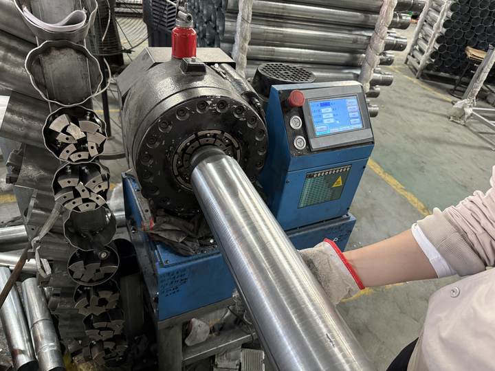 Steel tube end being formed in a tube-shrinking machine
