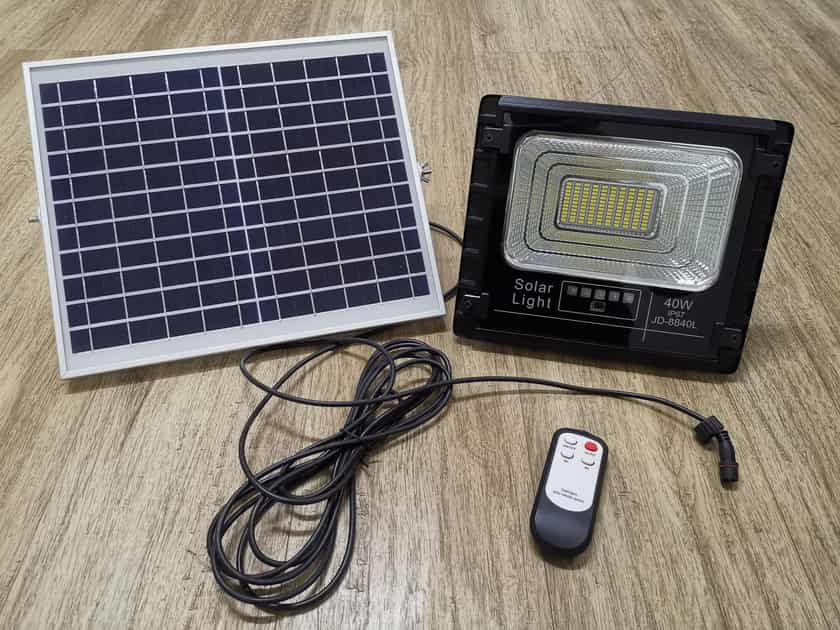 JD solar flood light kit with panel cable and remote laid out
