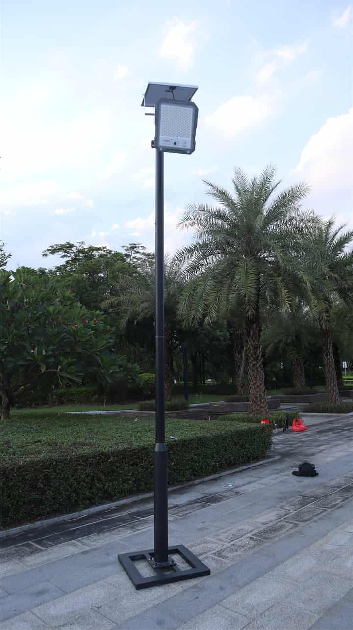 Separate panel flood light on a pole beside an outdoor path