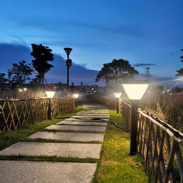 Solar garden lights beside a stone pathway at dusk