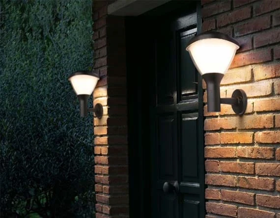 Two solar wall lights mounted beside a building entrance