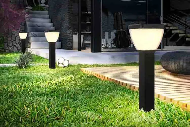 Solar garden lights beside grass and a landscape seating area