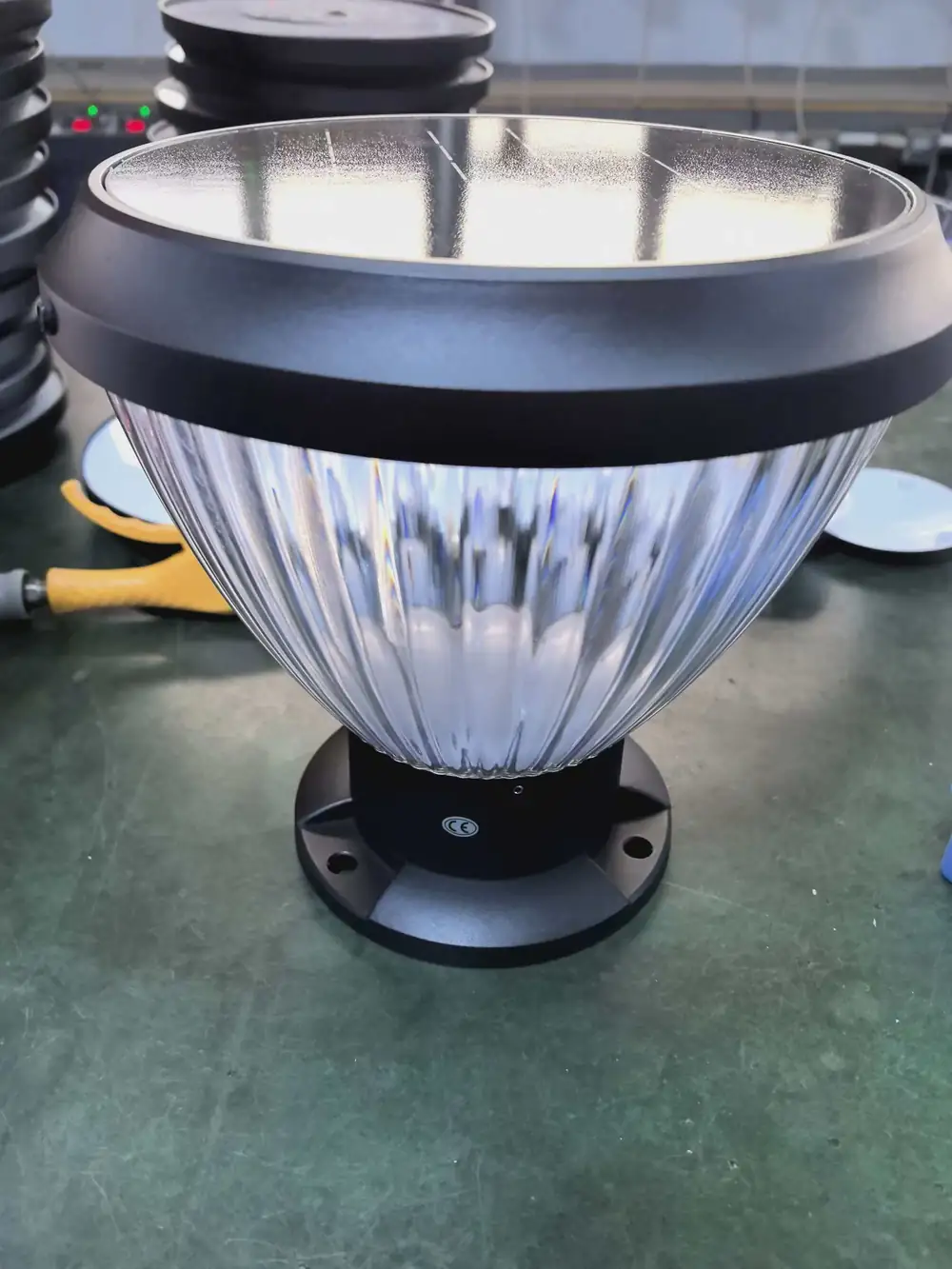 Pillar light on a workbench with a circular base and visible fixing holes