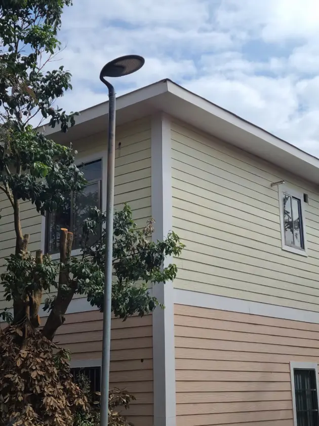 Pole-mounted courtyard lights beside buildings