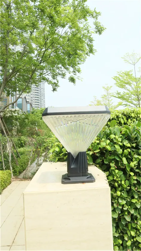 Pillar-top light on a low wall beneath foliage