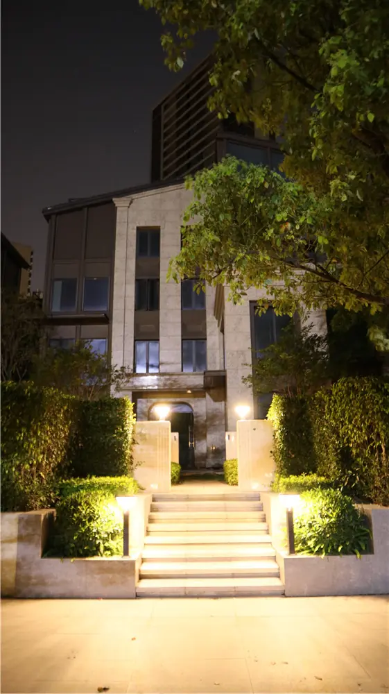 Night view of steps and a building entrance with low lighting