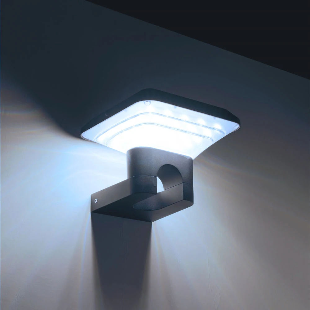 Illuminated wall light seen from below against two adjoining walls