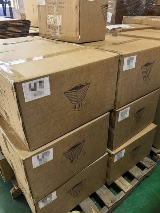 SWL-001B solar wall light cartons stacked on a pallet before dispatch